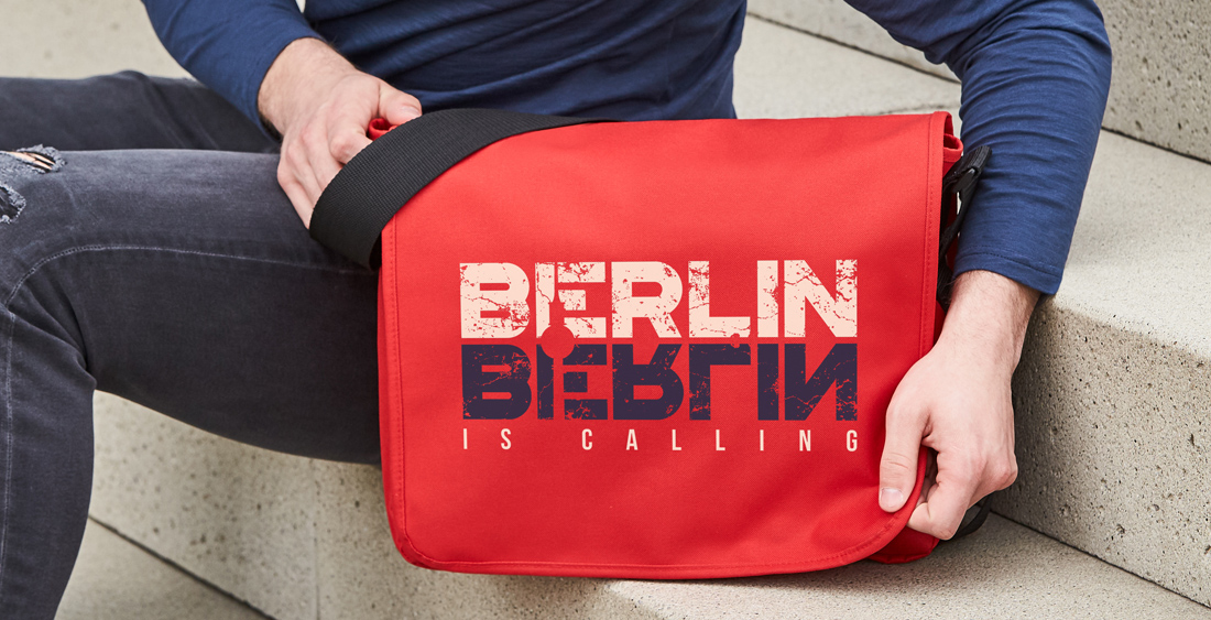 Printed shoulder bag as promotional bags presented on a staircase